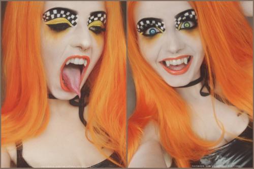 Model with orange wig & vampire fangs